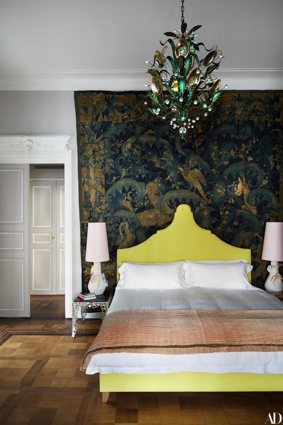 A 16th-century tapestry hangs on a bedroom wall. Tony Duquette abalone chandelier; side tables by Othoniel; lamps by Creten.