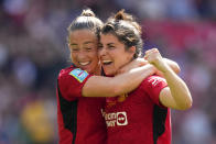 Manchester United's Lucia Garcia, right, celebrates with Maya Le Tissier after scoring her side's fourth goal during the Women's FA Cup final soccer match between Manchester United and Tottenham Hotspur at Wembley Stadium in London, Sunday, May 12, 2024. (AP Photo/Kirsty Wigglesworth)