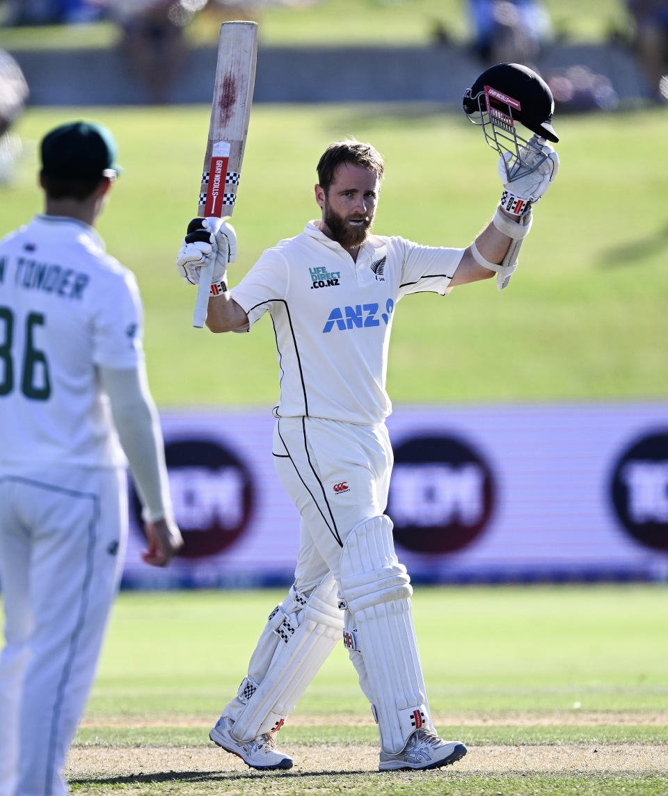 New Zealand's Kane Williamson celebrates his second innings century as South Africa's Raynard van Tonder, left, watches on day three of the first cricket test between New Zealand and South Africa at Bay Oval, Mt Maunganui, New Zealand, Tuesday, Feb. 6, 2024. (Photo: Andrew Cornaga/Photosport via AP)