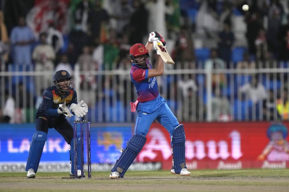 Afghanistan's Ibrahim Zadran, right, plays a shot while Sri Lanka's wicketkeeper Kusal Mendis watches during the T20 cricket match of Asia Cup between Sri Lanka and Afghanistan, in Sharjah, United Arab Emirates, Saturday, Sept. 3, 2022. (AP Photo/Anjum Naveed)