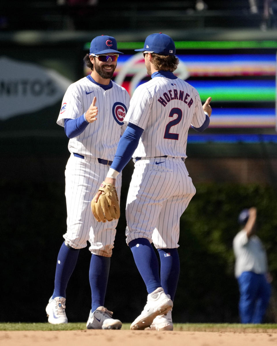 Chicago Cubs' Nico Hoerner (2) and Dansby Swanson celebrate the team's 8-3 win over the Miami Marlins in a baseball game Friday, April 19, 2024, in Chicago. (AP Photo/Charles Rex Arbogast)