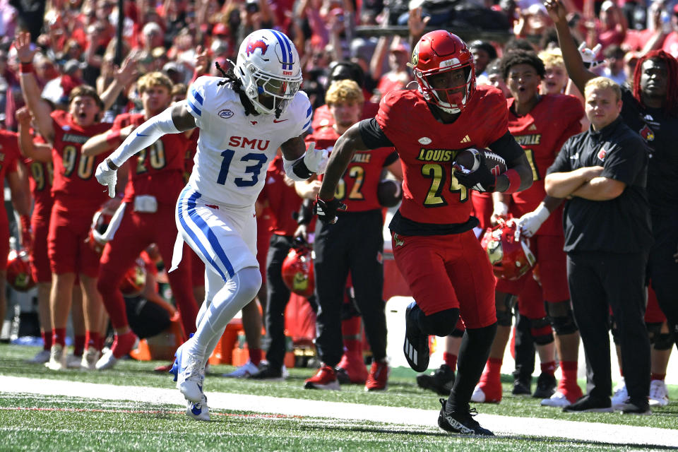 SMU cornerback Jaelyn Davis-Robinson (13) attempts to run down Louisville wide receiver Ahmari Huggins-Bruce (24) during the first half of an NCAA college football game in Louisville, Ky., Saturday, Oct. 5, 2024. (AP Photo/Timothy D. Easley)