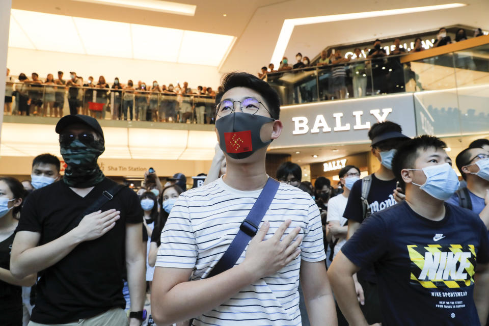 Anti-government protesters as people sing during a rally inside a shopping mall at Sha Tin district in Hong Kong Sunday, Sept. 22, 2019. Young protesters, many wearing masks to disguise their identity, filled the open area of a Hong Kong shopping mall Sunday and folded paper "origami" cranes in the latest twist in a pro-democracy movement that has stretched into a fourth month. (AP Photo/Kin Cheung)