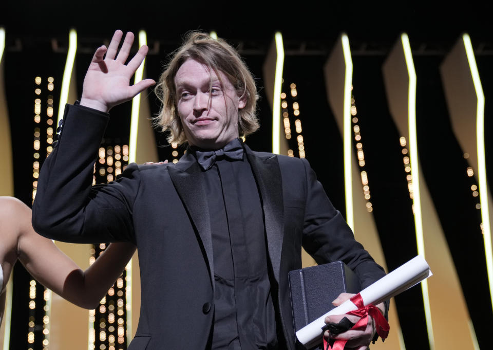 Caleb Landry Jones accepts the award for best actor for the film' Nitram' during the awards ceremony for the 74th international film festival, Cannes, southern France, Saturday, July 17, 2021. (AP Photo/Vadim Ghirda)