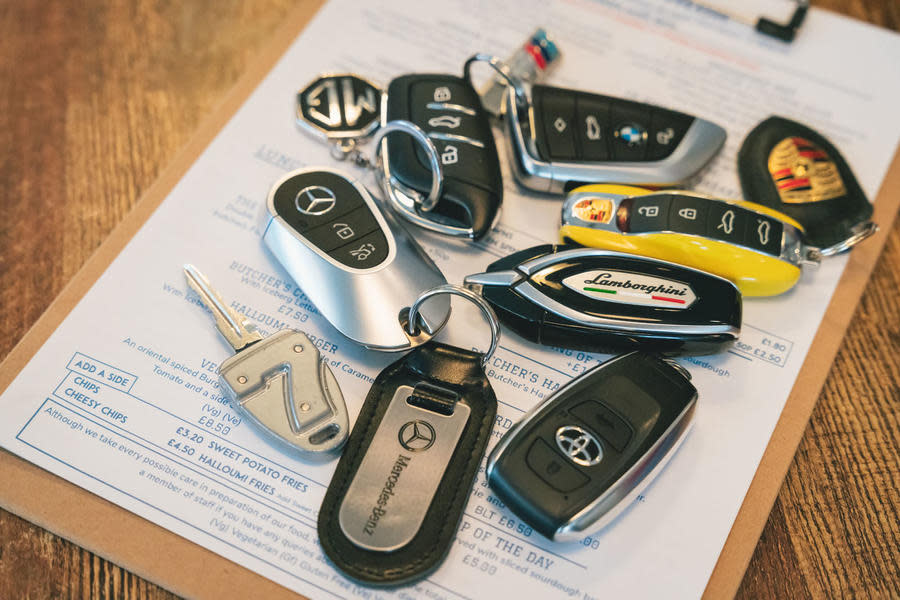 Several car keys are laid on a pub food menu