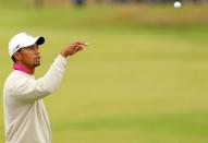 Tiger Woods of the US catches his ball on the 7th green during his first round on the opening day of the 2012 Open Championship at Royal Lytham & St Anne's in Lytham