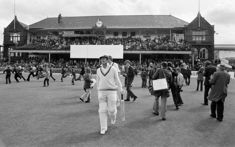Yorkshire batsman Geoffrey Boycott on the field as crowds rush on in 1973