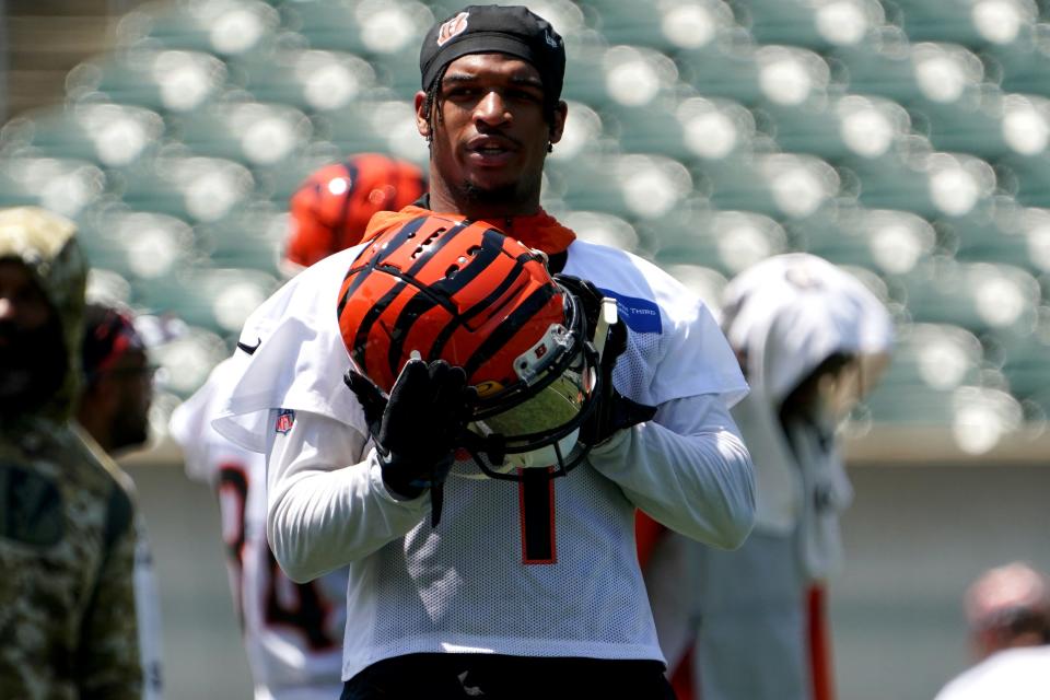 Cincinnati Bengals wide receiver Ja'Marr Chase (1) puts his helmet on between drills during organized team activities practice, Tuesday, June 14, 2022, at Paul Brown Stadium in Cincinnati.