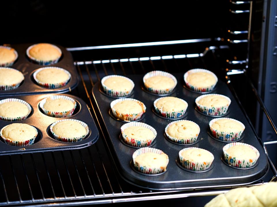 Several full muffin tins in the oven