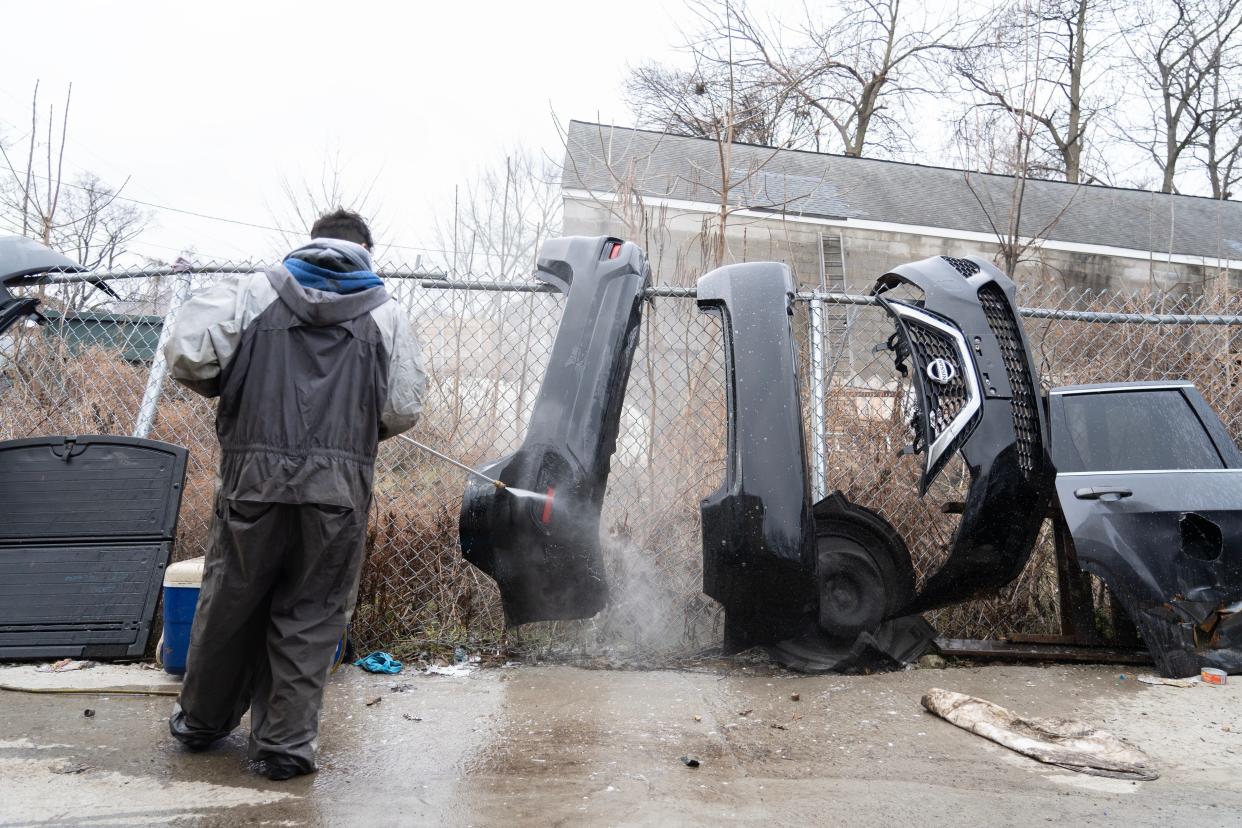 An employee at A&G Auto power washes vehicle parts that were sitting in flood water from the Passaic River in Paterson, NJ on Thursday Jan. 4, 2024. The latest flooding impacted several neighborhoods including side streets off of East Main St in Paterson, NJ.