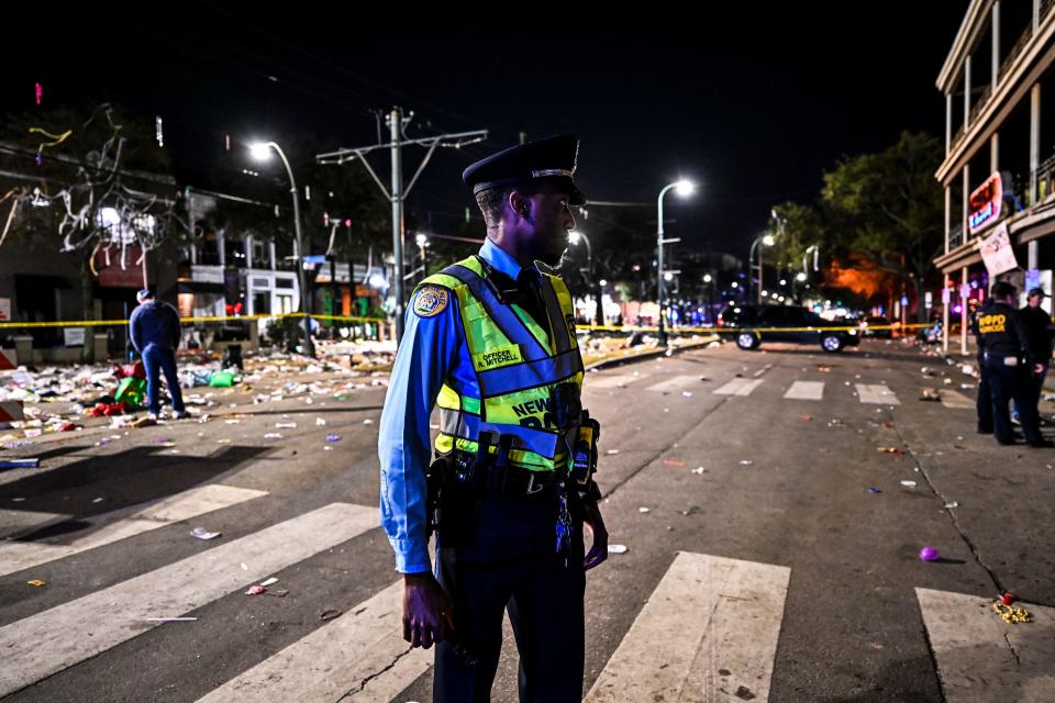 Police officers work at the scene of a shooting that occurred during the Krewe of Bacchus parade in New Orleans, February 19, 2023. / Credit: Chandan Khanna/AFP via Getty Images