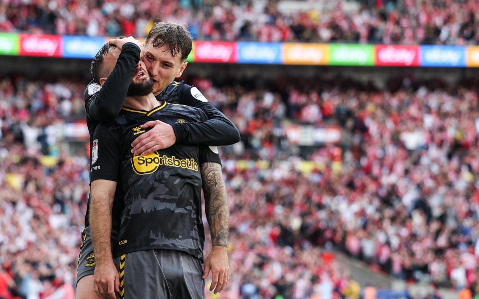 Southampton's English striker #09 Adam Armstrong (L) celebrates with Southampton's Welsh midfielder #36 David Brooks