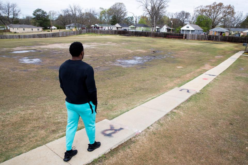 Melvin Cole, founder of PURE Academy, walks next to the field used for football practice while giving a tour of the academy in Memphis, Tenn., on Tuesday, March 26, 2024.