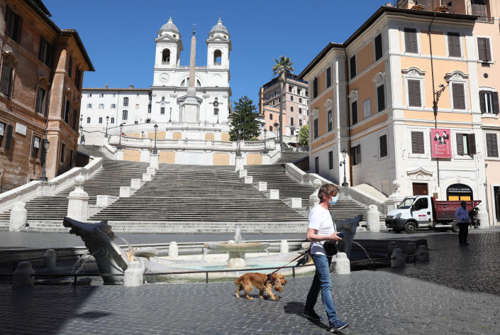 ROME, May 4, 2020 .A man walks his dog at the Piazza di Spagna in Rome, Italy, May 4, 2020.   The coronavirus pandemic has claimed over 29,000 lives in Italy, bringing the total number of infections, fatalities and recoveries to 211,938 as of Monday, according to the latest data released by the country's Civil Protection Department.    Italians enjoyed more liberties on Monday, as some restrictions on productive activities and personal movements were relaxed for the first time after almost eight weeks. (Photo by Cheng Tingting/Xinhua via Getty) (Xinhua/Cheng Tingting via Getty Images)