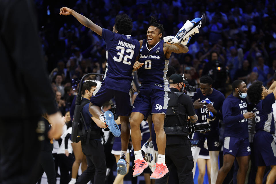 Jaylen Murray #32 and Latrell Reid #0 of the Saint Peter's Peacocks celebrate after defeating the Purdue Boilermakers 67-64 in the Sweet Sixteen round game of the 2022 NCAA Men's Basketball Tournament. (Tim Nwachukwu/Getty Images)