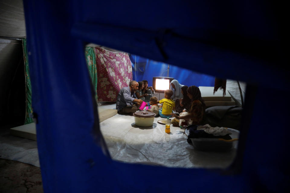 Displaced Iraqi family from Mosul eat a simple meal for their Iftar, during the Muslim holy month of Ramadan at a refugee camp al-Khazir in the outskirts of Erbil, Iraq, June 10.
