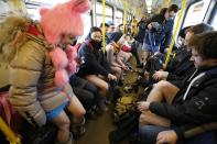 Passengers take off their pants as they use a subway during the "No Pants Subway Ride" event in Berlin January 12, 2014. The event is an annual flash mob and occurs in different cities around the world, according to its organisers. REUTERS/Fabrizio Bensch (GERMANY - Tags: SOCIETY ENTERTAINMENT)