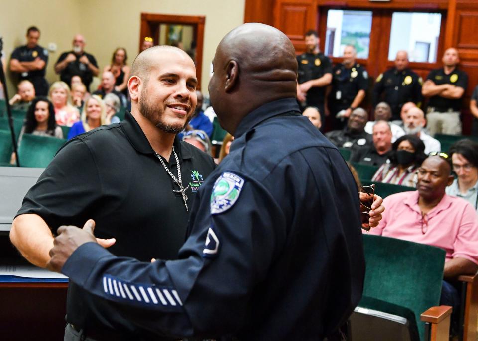 "He's the epitome of community police. When I think community police, I think about Thanksgiving Day, all those meals he helped us serve....Great to have someone always called upon, whether it's helping the homeless, helping a domestic violence victim, he was always there," said Michael Marsh (left), founder of nonprofit Team Success Enterprises. He congratulated Master Police Officer Darrell Rivers during his retirement ceremony, Friday, Jan. 20, 2023, at Vero Beach City Hall. Rivers served the community for 34 years.