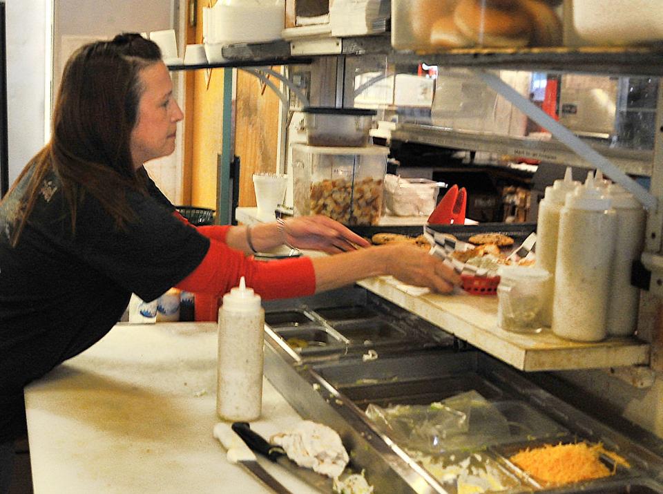 The Deli Planet Owner/Operator, Rebecca Rutledge prepares an order at her restaurant near Sheppard Air Force Base.