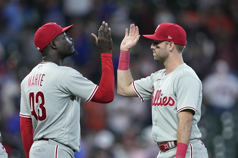 Philadelphia Phillies' Yunior Marte (43) and Kody Clemens celebrate after a baseball game against the Houston Astros Saturday, April 29, 2023, in Houston. The Phillies won 6-1. (AP Photo/David J. Phillip)