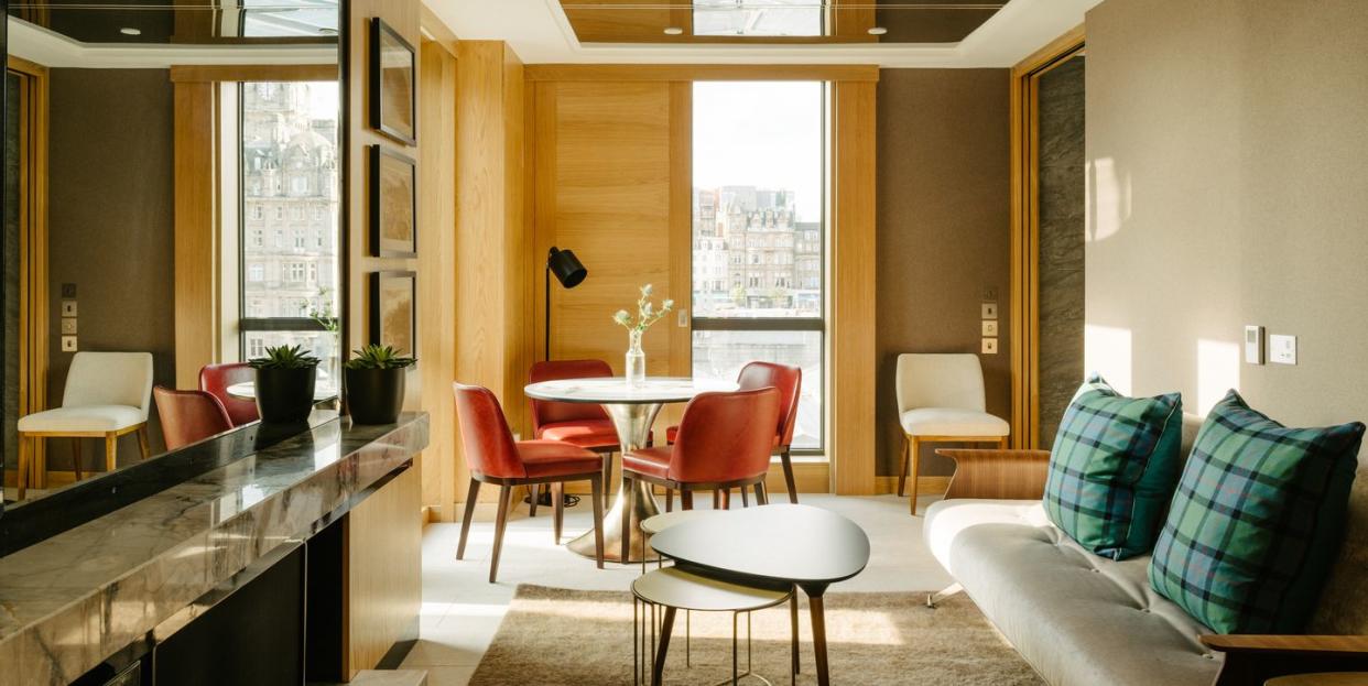 apartment room with sofa table and chairs at market street hotel