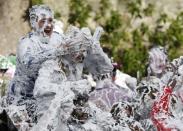 Students from St Andrews University are covered in foam as they take part in the traditional 'Raisin Weekend' in the Lower College Lawn, at St Andrews in Scotland, Britain October 17, 2016. REUTERS/Russell Cheyne