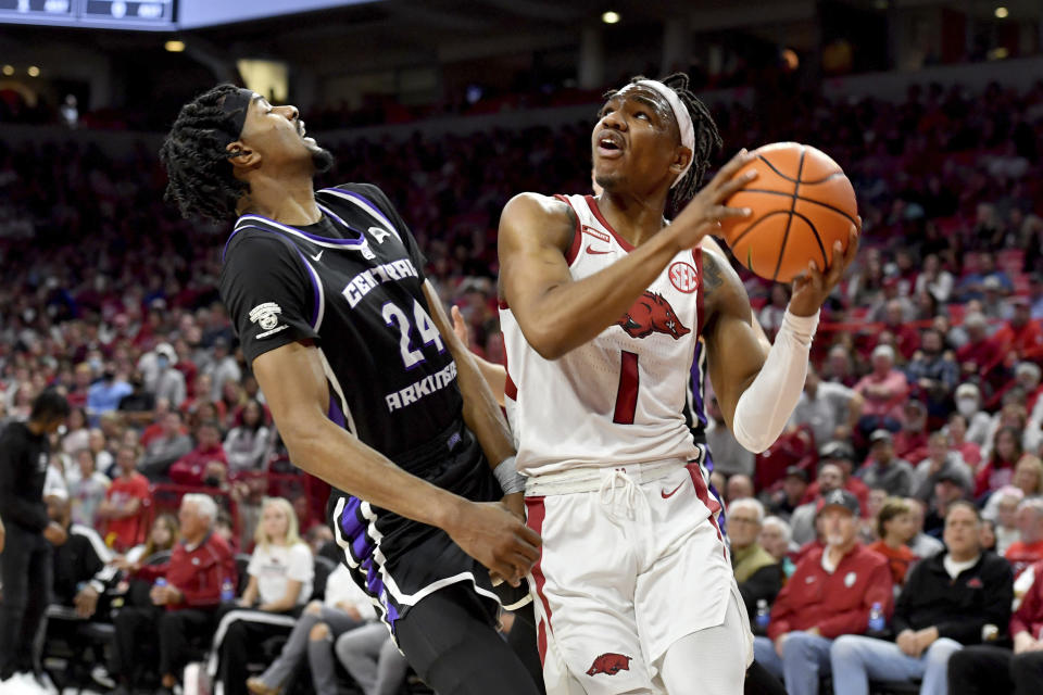 Arkansas guard JD Notae (1) is fouled by Central Arkansas forward Jared Chatham (24) during the first half of an NCAA college basketball game Wednesday, Dec. 1, 2021, in Fayetteville, Ark. (AP Photo/Michael Woods)