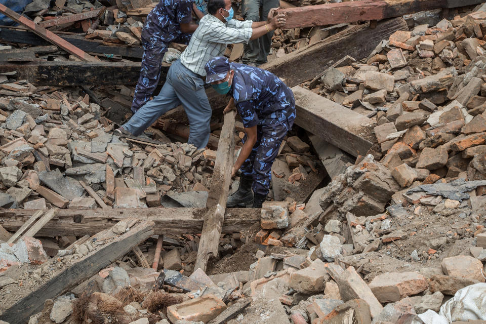 Volunteers and emergency workers search for bodies buried under the debris of one of the temples at Basantapur Durbar Square on April 27, 2015 in Kathmandu, Nepal.  (Photo by Omar Havana/Getty Images)