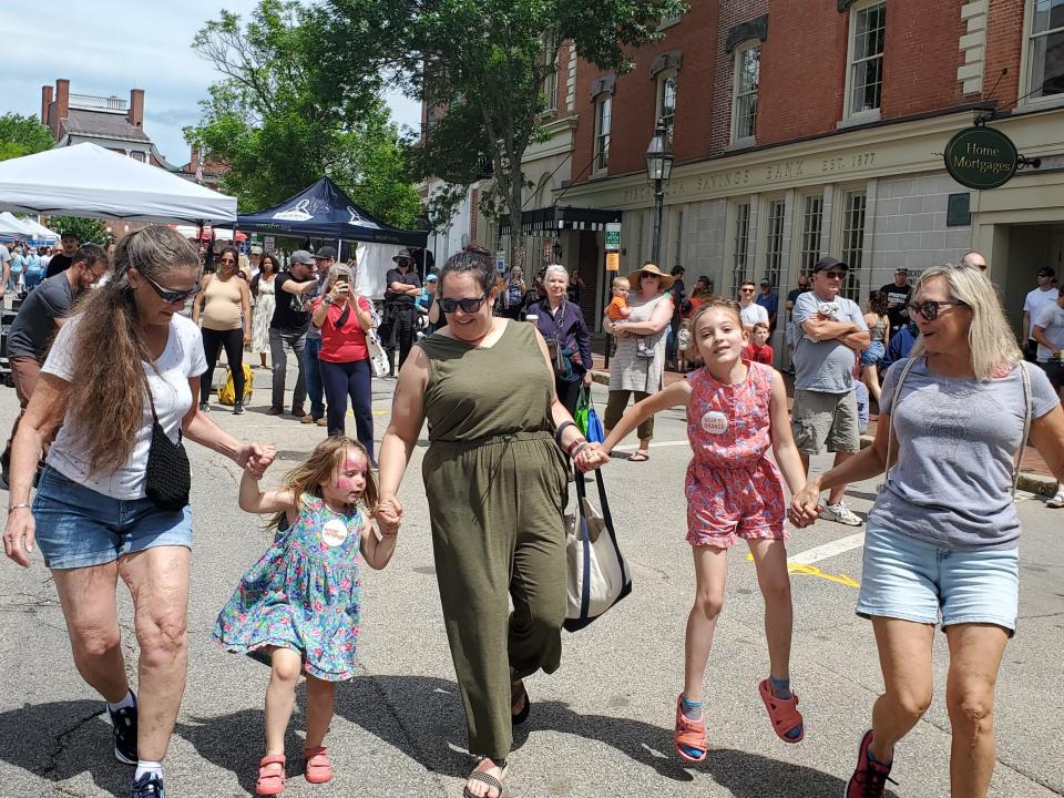 Kim Moore, Delphine Doucet, 3, Samantha Doucet, Olympia Doucet, 6, and Lucy Hurley were "moved" by the Maine Marimba Ensemble, playing at Market Square Day Saturday.