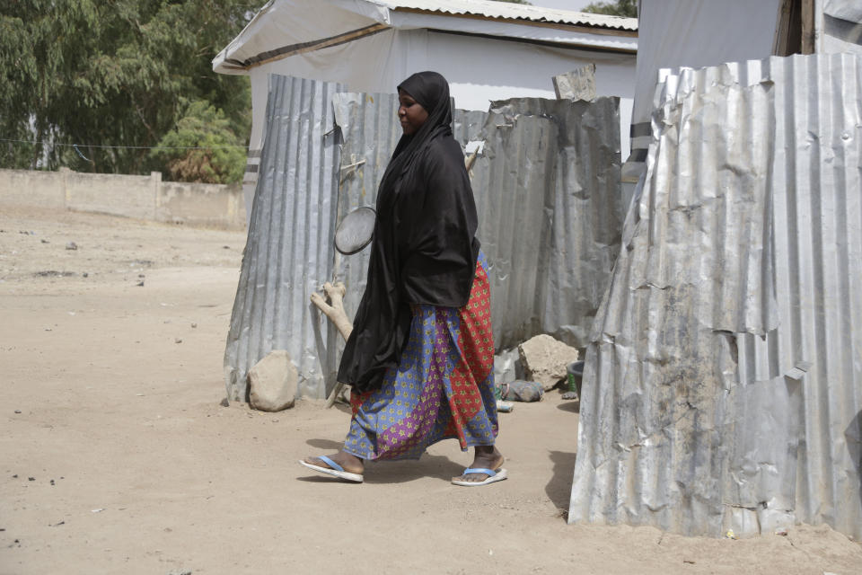 In this photo taken on Thursday, Feb. 21, 2019, Maria Saleh a woman who says she was assaulted and displaced by Islamist extremist is photographed at Malkohi camp in Yola, Nigeria. Maria is from the town of Madagali in Adamawa, has a child by a Boko Haram fighter who assaulted and then enslaved her for months following a 2014 attack that killed her husband. Two of her children were taken by militants. (AP Photo/ Sunday Alamba)