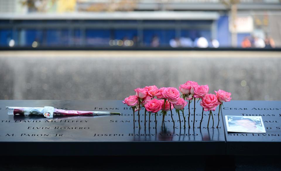 Flowers and a picture are placed in the wall at the 9/11 Memorial during a ceremony marking the 12th Anniversary of the attacks on the World Trade Center in New York September 11, 2013. (REUTERS/David Handschuh)