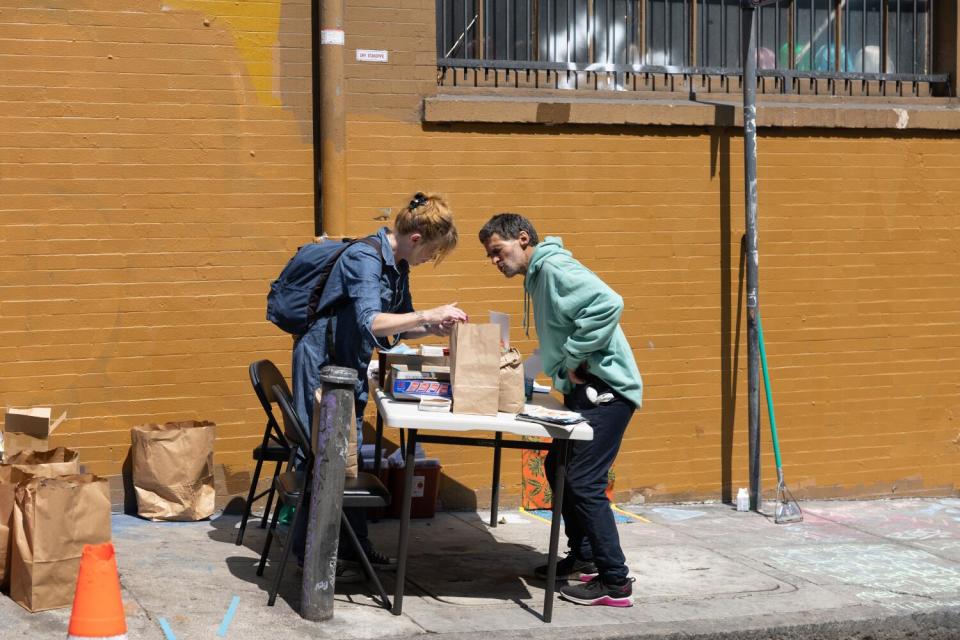 Terry Morris hands out drug paraphernalia at an illegal injection popup site on Willow and Polk Streets in San Francisco.