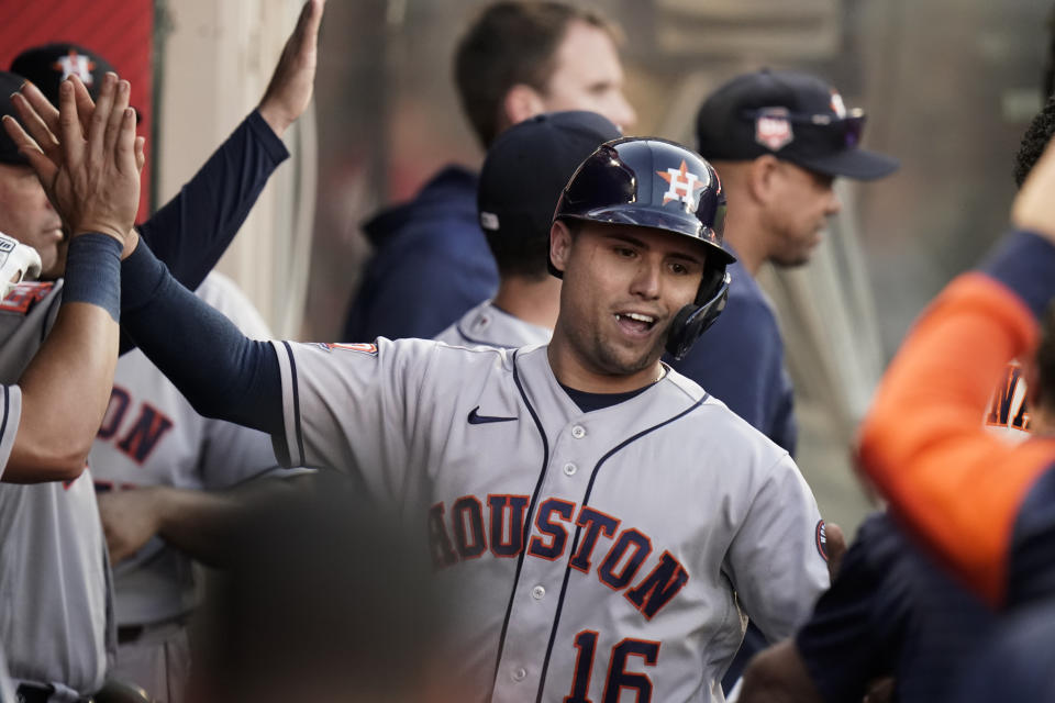 Houston Astros' Aledmys Diaz is congratulated by teammates after he scored on a single hit by Alex Bregman during the third inning of a baseball game against the Los Angeles Angels Tuesday, July 12, 2022, in Anaheim, Calif. (AP Photo/Jae C. Hong)