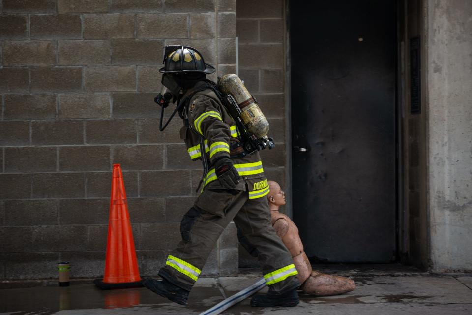 Corpus Christi Fire Capt. Jeff Durrwachter drags a dummy from a burning building during a structural firefighting and emergency medical demonstration at Del Mar College Windward Campus on Wednesday, May 15, 2024, in Texas.