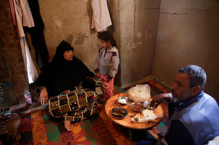 Om Ahmed, 45 years old talks with her daughter and husband Mahmoud at their house in Egypt's Nile Delta village of El Shakhluba, in the province of Kafr el-Sheikh, Egypt May 5, 2019. Picture taken May 5, 2019. REUTERS/Hayam Adel