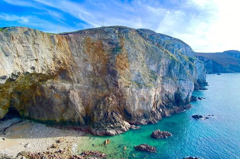 North Stack's vast Parliament House Cave, so called because its garrulous seabirds seem to squabble like politicians. Viewed from above on a summer's day, visitors remark on the scene's Mediterranean feel