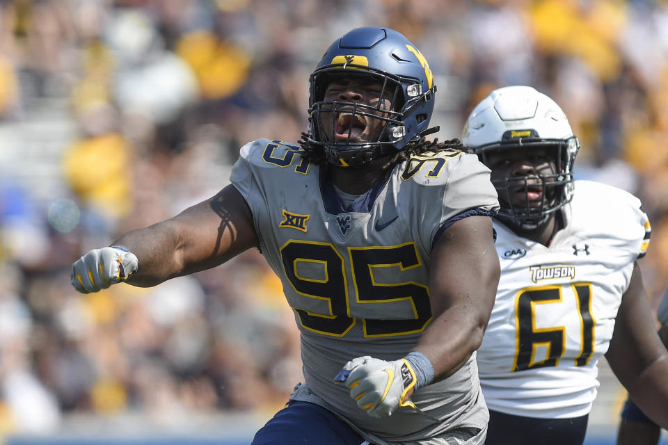 West Virginia defensive lineman Jordan Jefferson (95) reacts after making a play against Towson during the first half of an NCAA college football game in Morgantown, W.Va., Saturday, Sept. 17, 2022. (AP Photo/William Wotring)