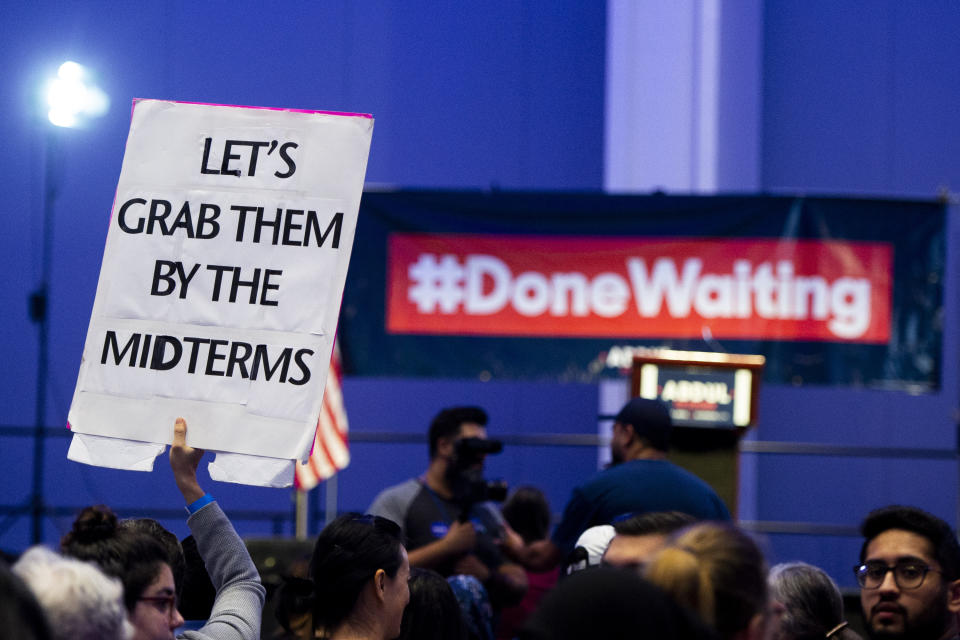 Heather Heine of Ferndale holds a sign that reads "Let's grab them by the midterms" at a Get Out The Vote rally for Michigan Democratic gubernatorial candidate Abdul El-Sayed at Cobo Center in Detroit on Sunday, Aug. 5, 2018. (Jacob Hamilton/Ann Arbor News via AP)