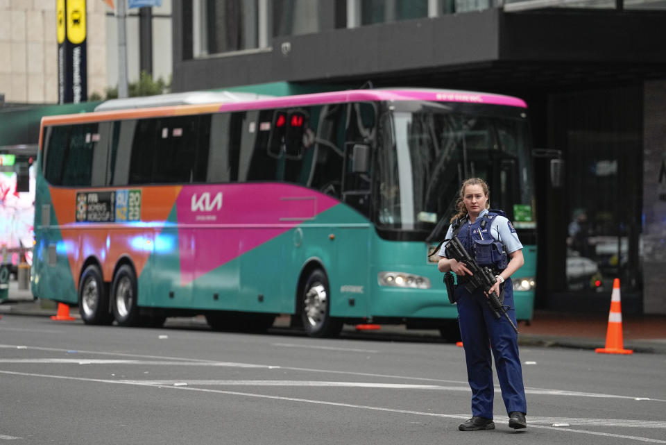 Armed New Zealand police officers stand outside a hotel housing a team from the FIFA Women's World Cup in the central business district following a shooting in Auckland, New Zealand, Thursday, July 20, 2023. New Zealand police are responding to reports that a gunman has fired shots in a building in downtown Auckland. (AP Photo/Abbie Parr)