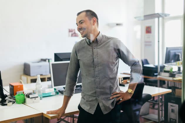 Short standing breaks can help prevent back aches if you work at a desk all day. (Photo: Hinterhaus Productions via Getty Images)