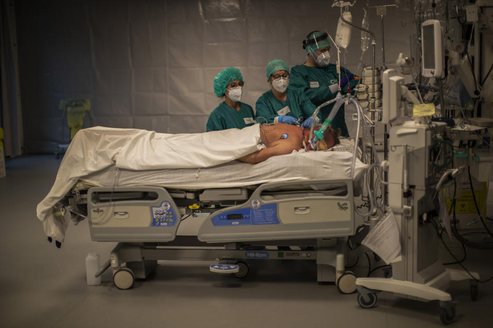 Medical personnel work in the intensive care ward for COVID-19 patients at the MontLegia CHC hospital in Liege, Belgium, Friday, Nov. 6, 2020. Coronavirus cases have surged around Europe in recent weeks, putting fresh pressure on overworked medical staff and hospitals, and forcing several countries to impose tough new movement restrictions. (AP Photo/Francisco Seco)