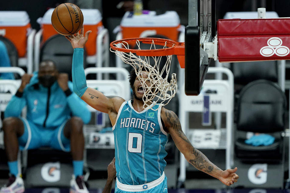 Charlotte Hornets forward Miles Bridges (0) is fouled while shooting against the Phoenix Suns during the first half of an NBA basketball game, Wednesday, Feb. 24, 2021, in Phoenix. (AP Photo/Matt York)
