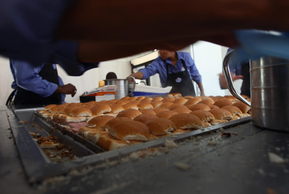 WASHINGTON, DC - JUNE 14:  White Castle employees cook their slider burgers before delivering them at the U.S. Capitol to celebrate the company's 90th anniversary with a "Castles at the Capitol" event June 14, 2011 in Washington, DC. Representatives of the Columbus, Ohio-based company hand-delivered their slider burgers to waiting congressional employees during their lunch hour.  (Photo by Win McNamee/Getty Images)