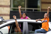 People in cars speak to protesters, Friday, Sept. 25, 2020, in Louisville. Breonna Taylor's family demanded Friday that Kentucky authorities release all body camera footage, police files and the transcripts of the grand jury hearings that led to no charges against police officers who killed the Black woman during a March drug raid at her apartment. (AP Photo/Darron Cummings)