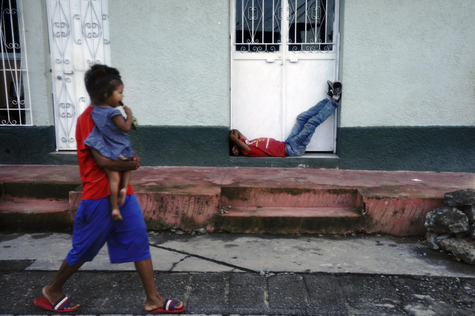 Migrants, mostly from Central America, use the day to rest in Huixtla, Chiapas state, Mexico, early Tuesday, Oct. 26, 2021, during their trek by foot toward the U.S. (AP Photo/Marco Ugarte)