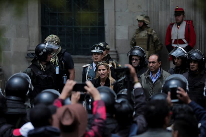 Bolivian Interim President Jeanine Anez takes part in a ceremony with the police in front of the Presidential Palace, in La Paz