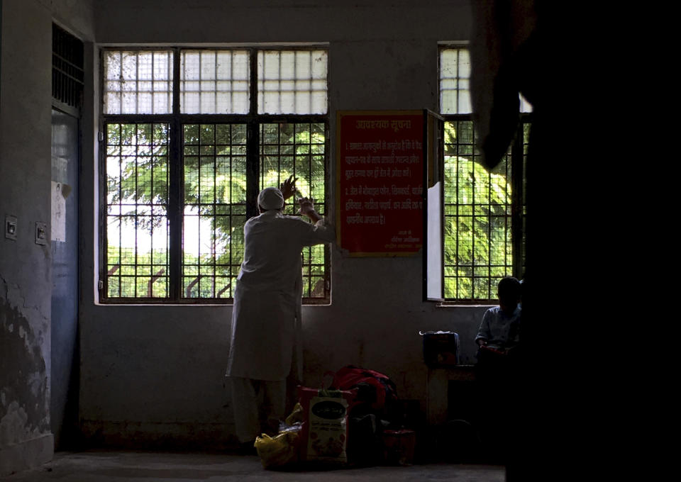 A Kashmiri man holds on to iron grills of a window as he awaits his turn to meet his son at Agra Central Jail in Agra, India, Friday, Sept. 20, 2019. Families from the Himalayan region of Kashmir have traveled nearly 1,000 kilometers (600 miles) in sweltering heat to meet relatives being held in an Indian jail in the city of Agra. At least 4,000 people, mostly young men, have been arrested in Indian-held Kashmir since the government of Prime Minister Narendra Modi imposed a security clampdown and scrapped the region’s semi-autonomy on Aug. 5, according to police officials and records reviewed by AP. (AP Photo/Altaf Qadri)