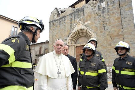 Pope Francis talks with firefighters in Amatrice, Italy, October 4, 2016. REUTERS/Osservatore Romano/Handout via Reuters