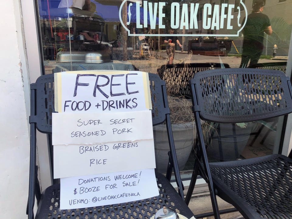 The Oak Street Café in New Orleans offers free food to passers-by on Thursday, Sept. 2, 2021, as the city recovers from damage and power outages caused by Hurricane Ida. (AP Photo/Kevin McGill)
