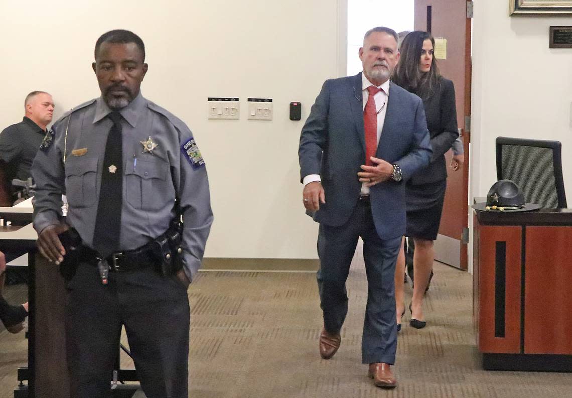 Jody Greene enters a courtroom in the Columbus County Courthouse Monday morning for a removal hearing. He is followed by his wife, Angela Greene.